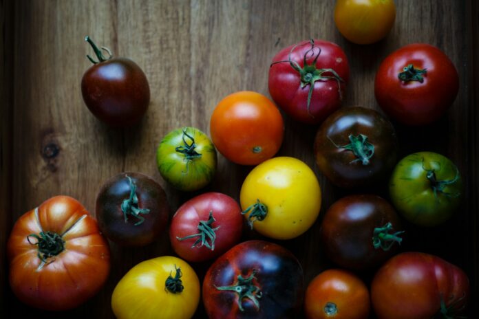 Photo by Vince Lee assorted-color tomatoes on brown wooden surface
