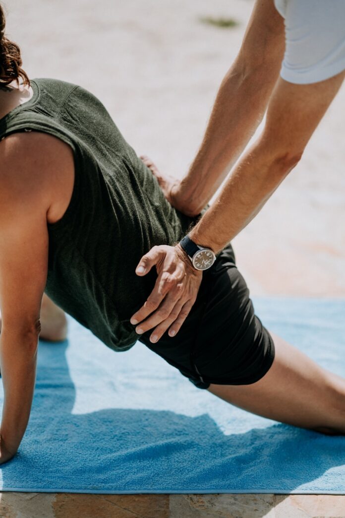 Photo by Annie Spratt person pressing man back kneeling on blue towel
