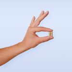 ‘영양 보충제, 어떻게 챙길까?’ 바쁜 일상 속 건강 지키는 실생활 팁 A person's hand with a ring on it